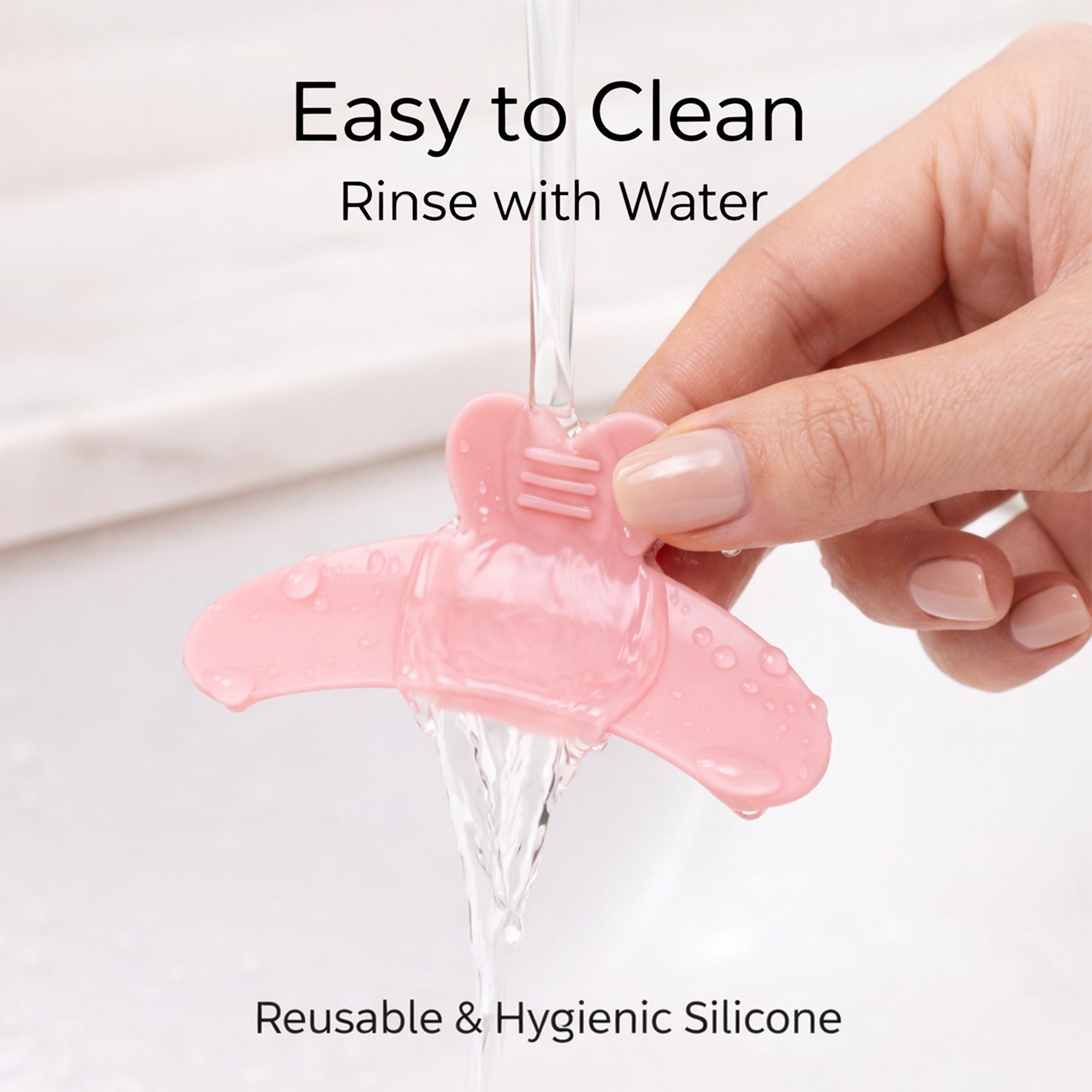 Pink reusable YSEN’S reverse lash lift shield being rinsed with water during the cleaning process