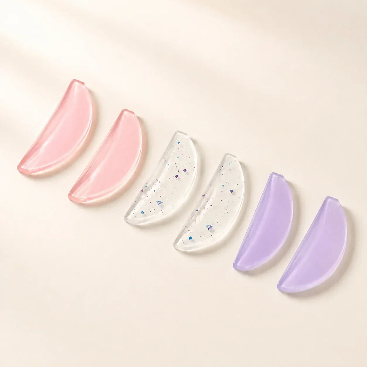 Lash artist positioning silicone pads during a professional lash lift treatment