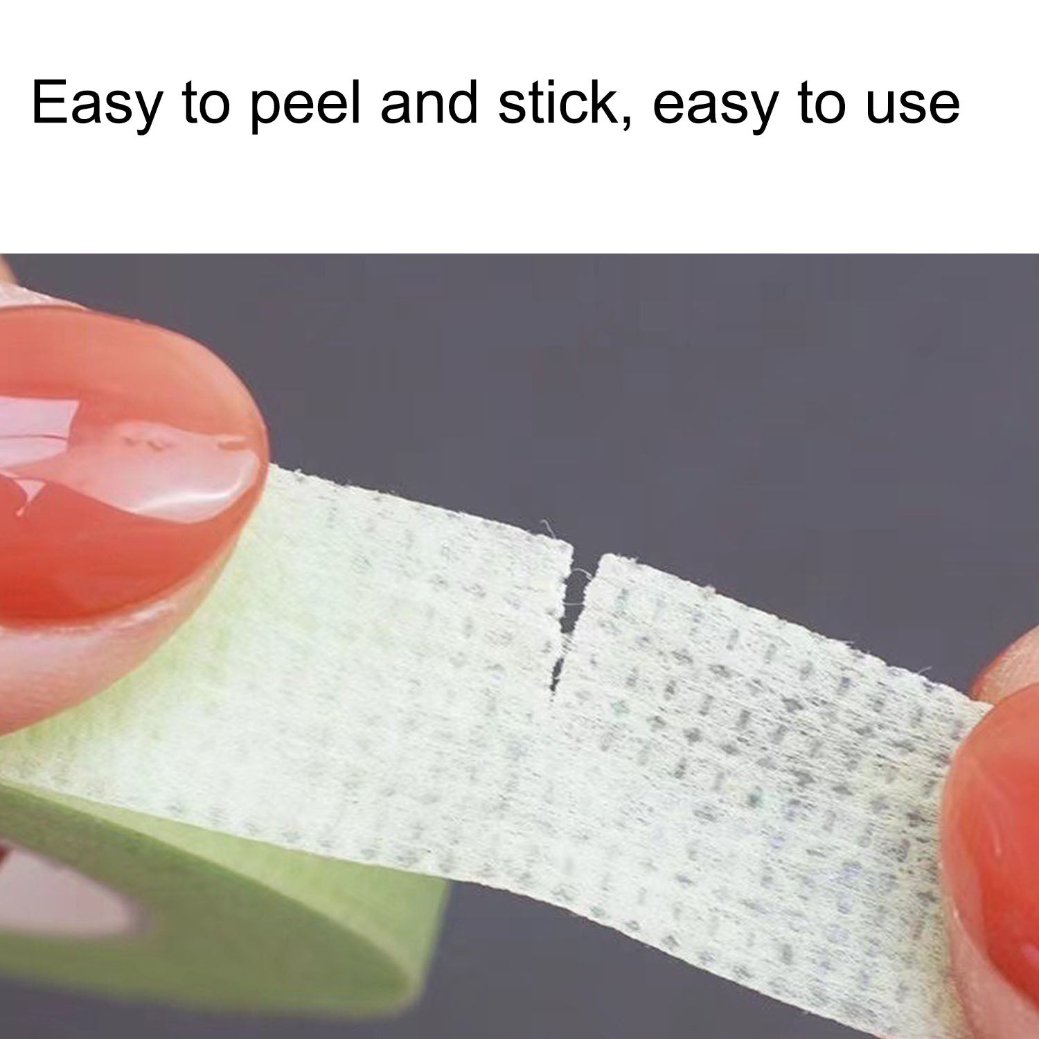 Close-up of green YSEN’S micropore lash tape being torn by hand